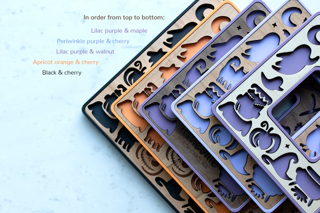 Mini Halloween decor picture frames with laser cut Halloween shapes, including black cats, ghosts, and pumpkins. Frames are available in purple, orange, and black with wooden inlays.