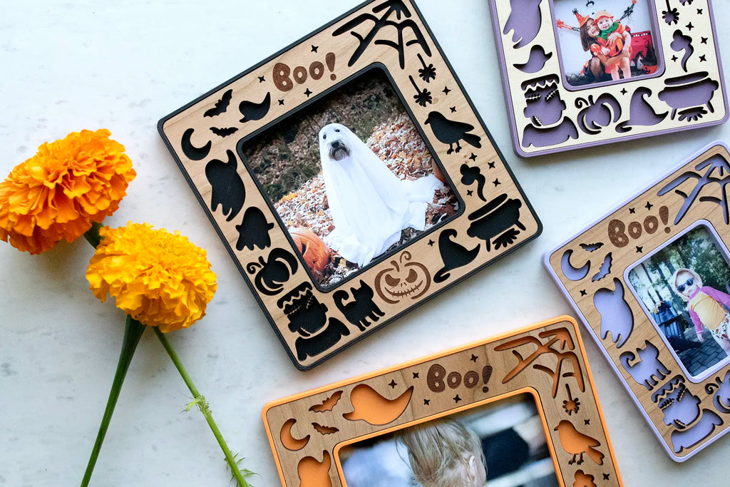 Halloween keepsake frames with magnets for cute Halloween decor. Frames come in several colors and feature cute ghosts, pumpkins, a moon and stars, and witch's hat. Frames are pictured with photographs of kids and dogs in Halloween costumes.