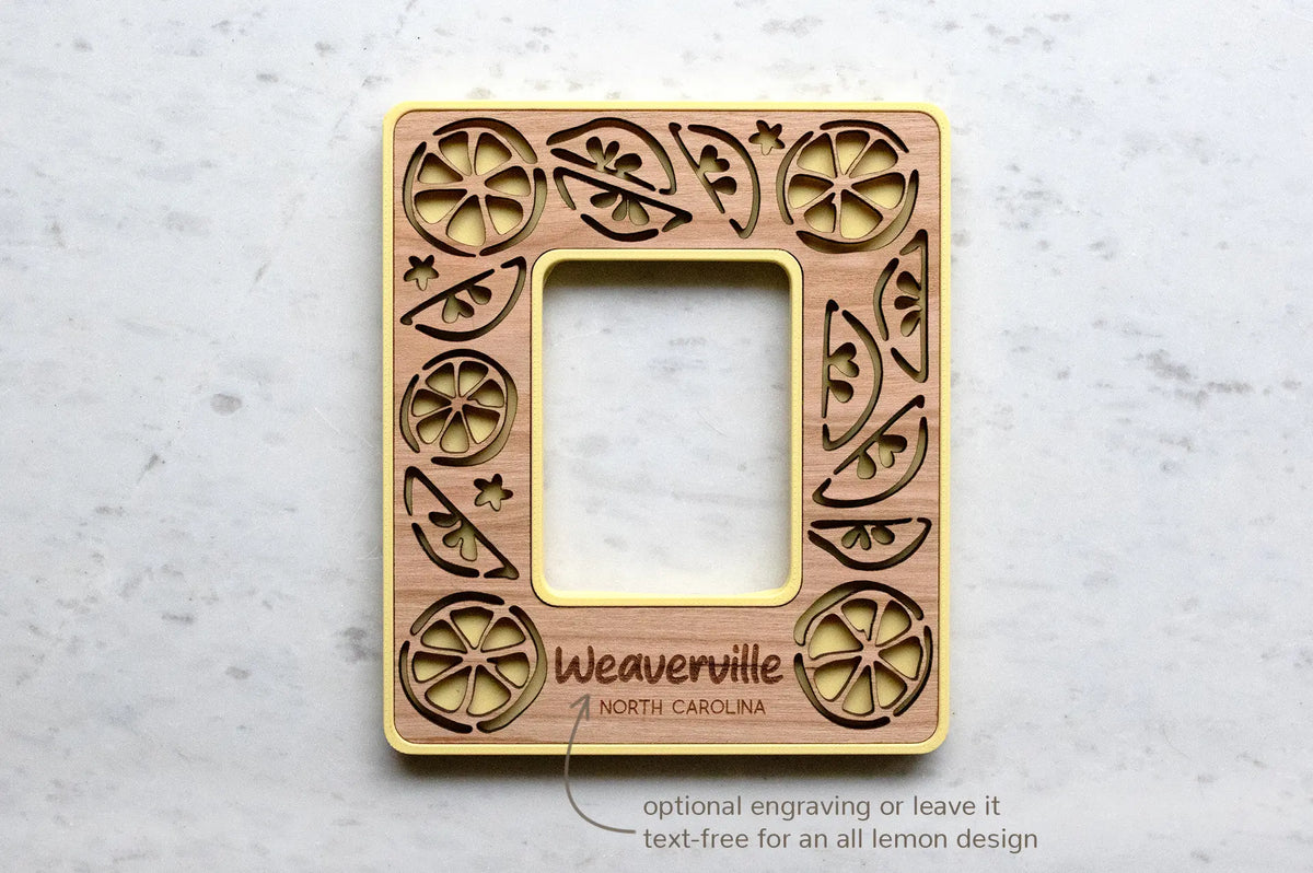 Lemon mini magnetic photo frame with optional engraved message on bottom. This frame reads "Weaverville North Carolina" in engraved text. Engraving is optional, and frames can be kept text-free for an all lemon design.