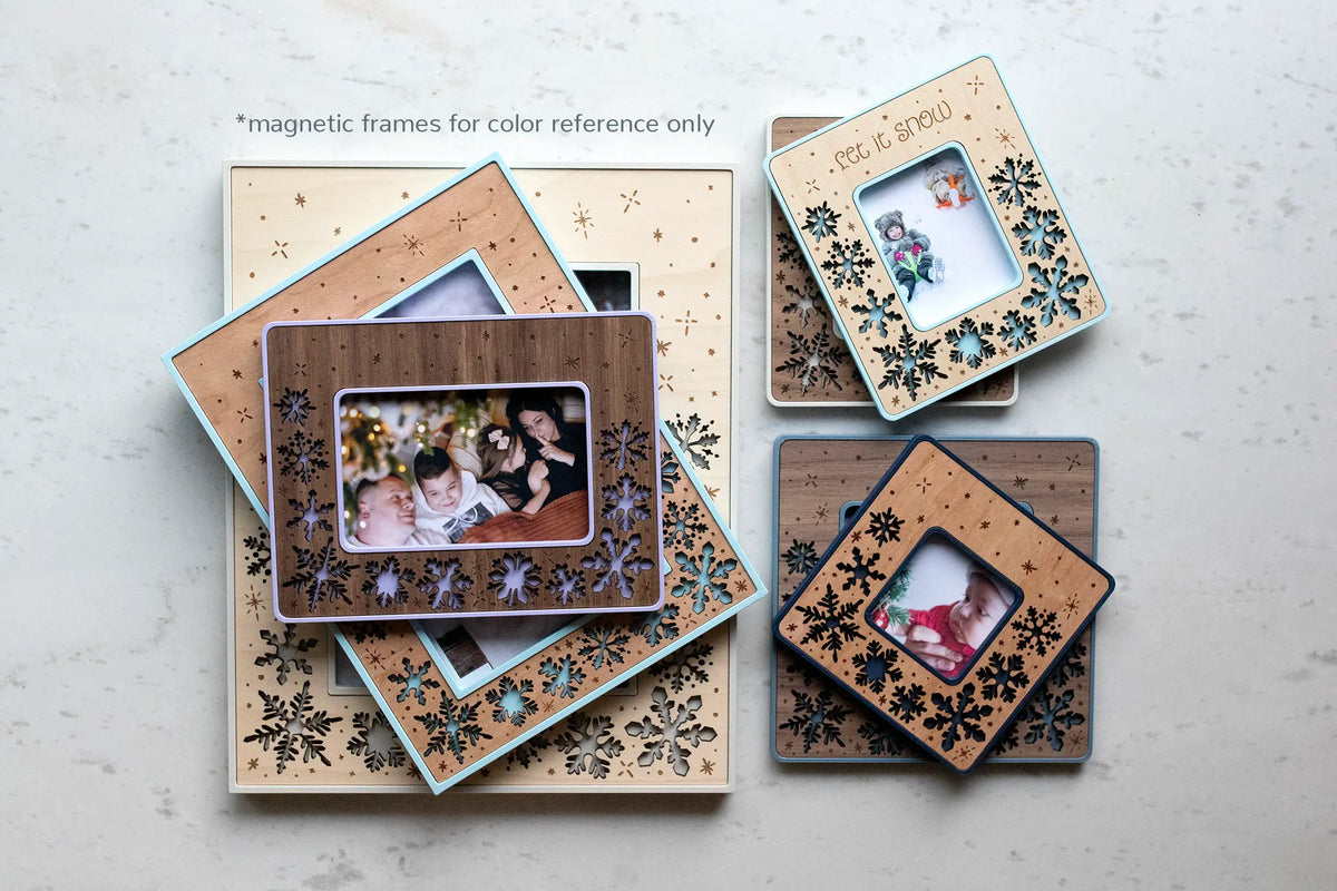 Christmas snowflake holiday frames pictured in an assortment of various colors and wood types. Frames are customizable with laser engraved message or can be left as is with snowflake-only designs.