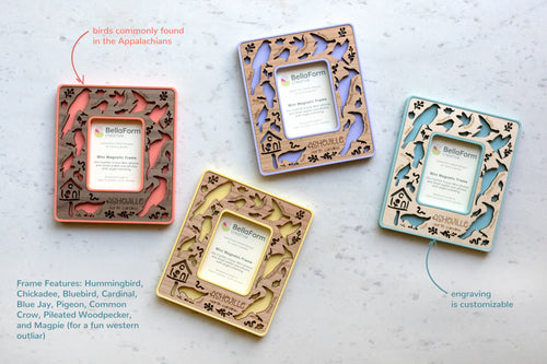 Four magnetic instax mini frames in various colors and wood types. The frames are coral pink, purple, light blue, and yellow. The wood inlays feature birds of the carolinas, including the cardinal, chickadee, blue jay, and bluebird.