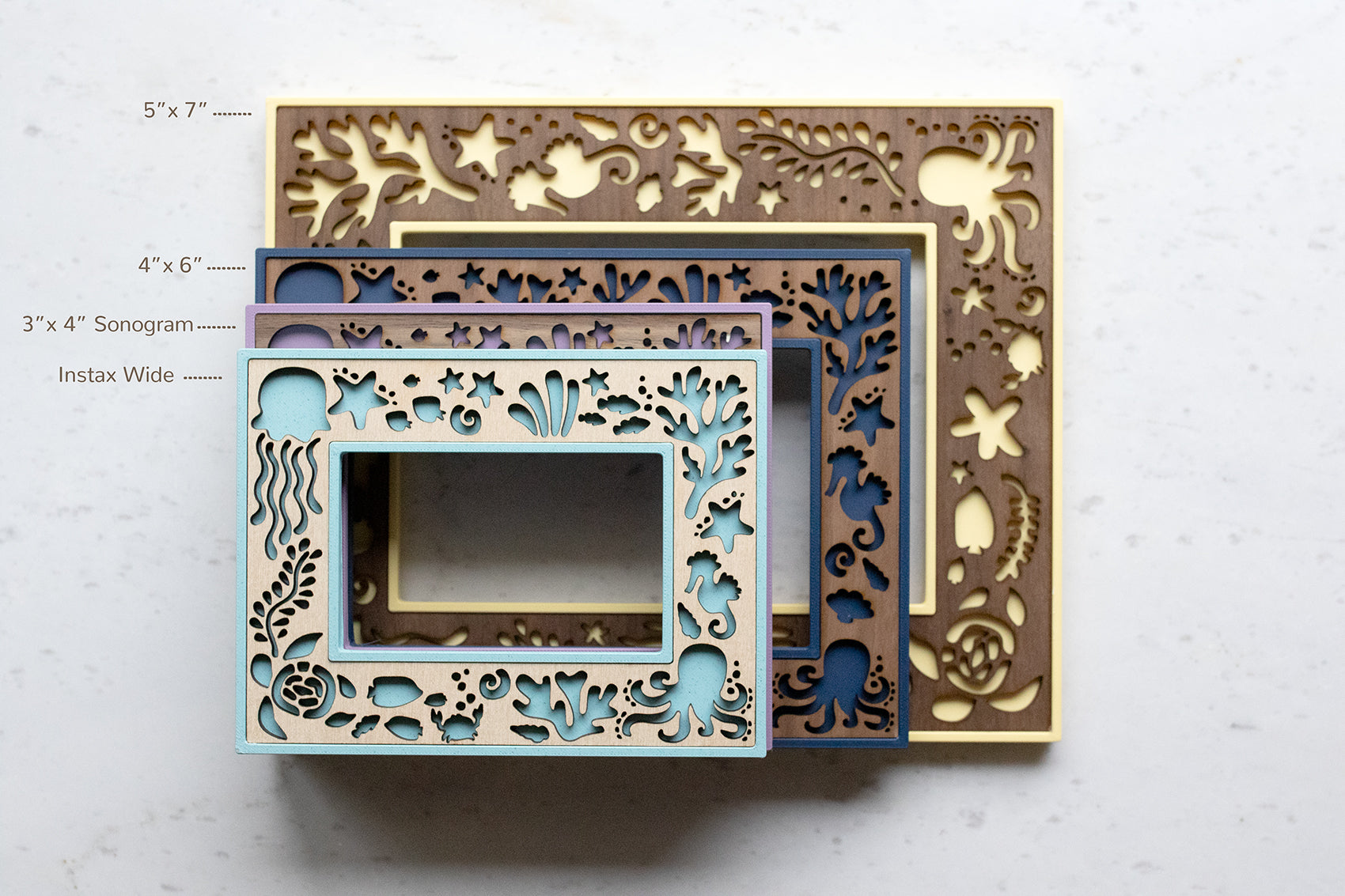 Front view of four available frame sizes in various colors including: 5x7 inch, 4x6 inch, 3x4 inch sonogram, and Polaroid sized for Fujifilm Instax Wide film. Frames are designed for ocean lovers and beach houses.