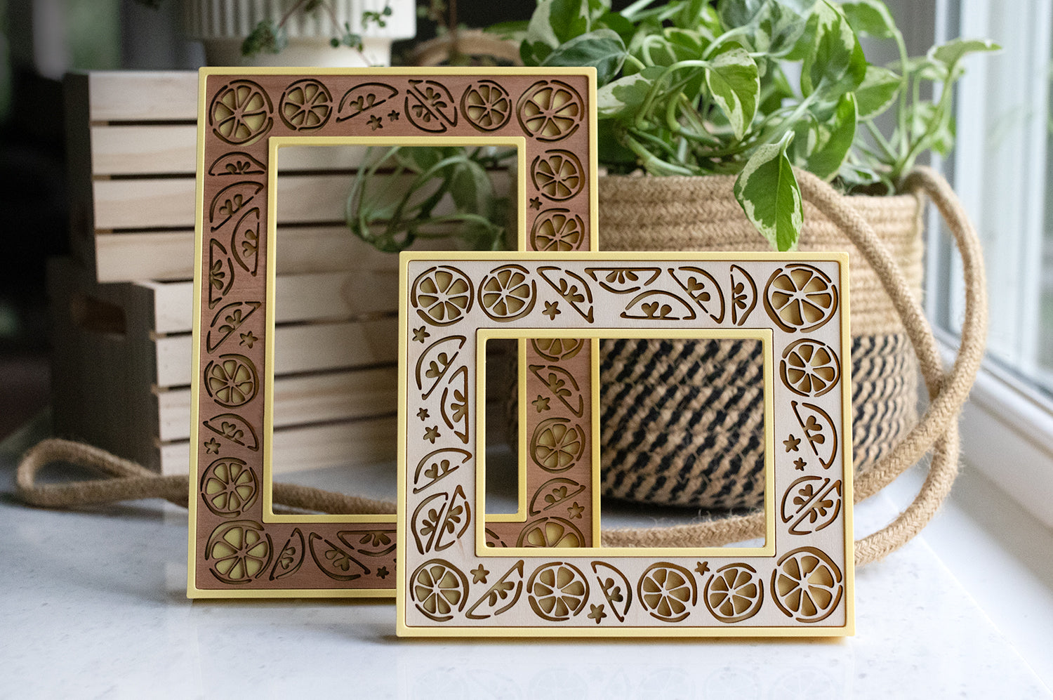 Two laser cut lemon frames with yellow 3D printed housing and cherry wood inlay. The frames can be personalized with a cute fruit-themed custom message to make a lemon lover gift.