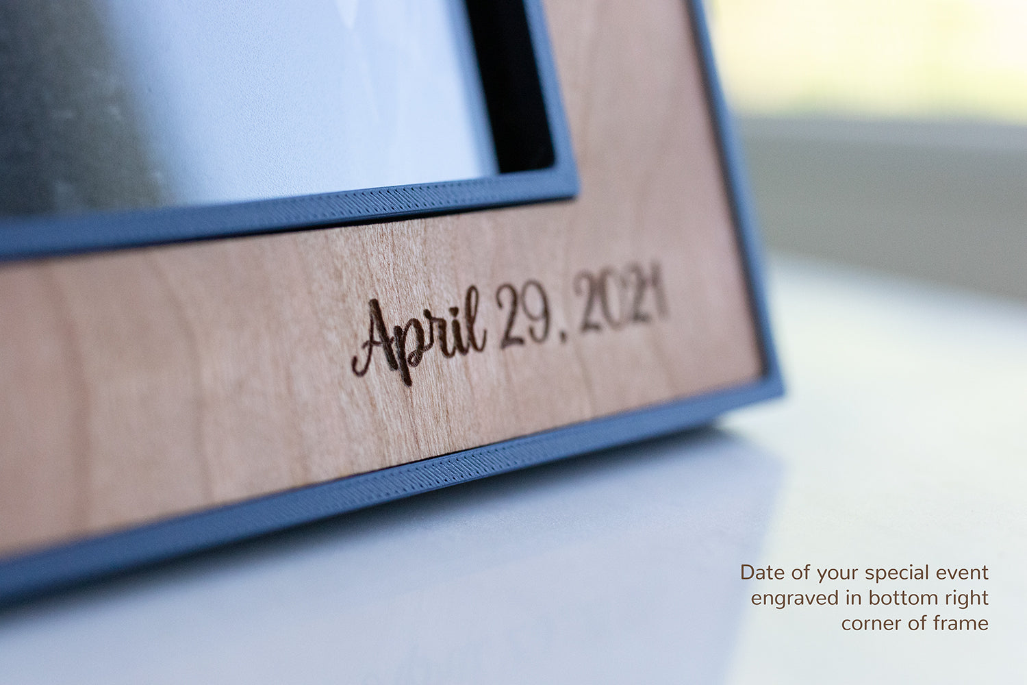 A close-up detail view of an engraved wedding date that reads "April 29, 2021". The engraving is on a beautiful cherry wooden inlay. In the corner of the image, the words "Date of your special event engraved in bottom right corner of the frame" are present.