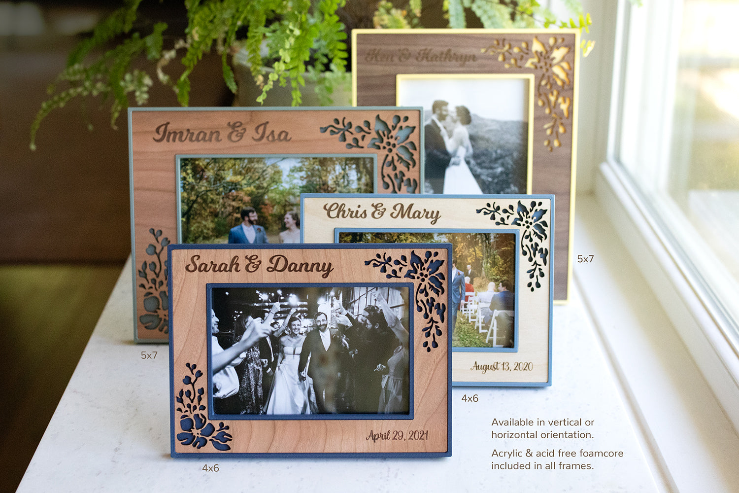 An assortment of wedding picture frames shown in 5x7 inch sizes and 4x6 inch sizes. The frames are pale yellow, sage green, slate blue, and navy blue with various colored wooden borders. The image reads "Available in vertical or horizontal orientation. Acrylic and acid free foamcore included in all frames."