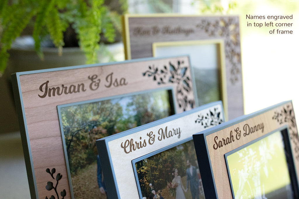 Four custom wedding frames with personalized engraved names in the top leftmost corner of the frames. Engravings include: "Imran & Isa", "Chris & Mary", "Sarah & Danny", and "Ken & Kathryn."