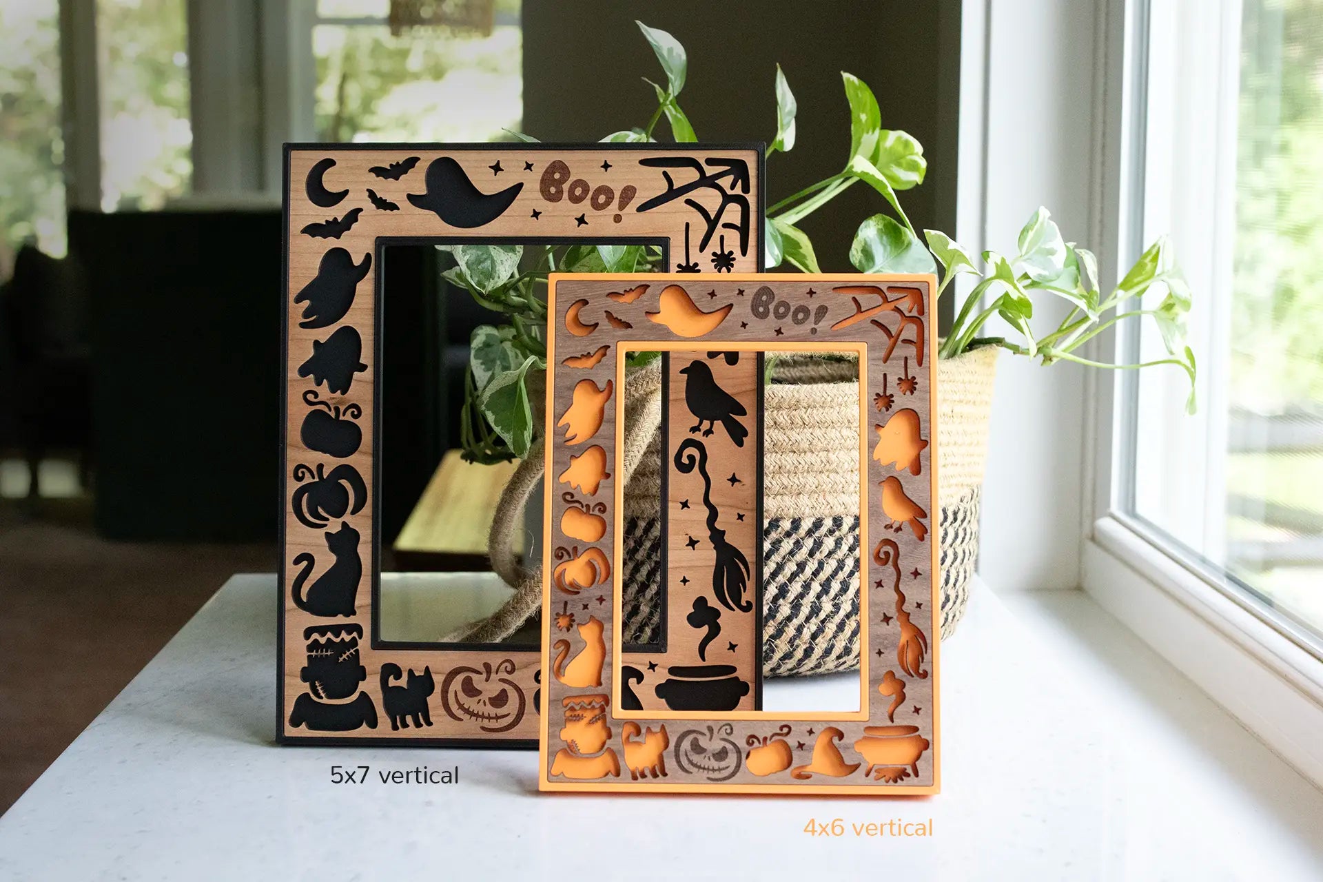 Black and orange halloween frames with laser cut wooden inlays, featuring black cats, a haunted night sky, cute ghosts, and pumpkins. Frames are made-to-order and are available in a variety of colors and wood types with the option for custom engravings.