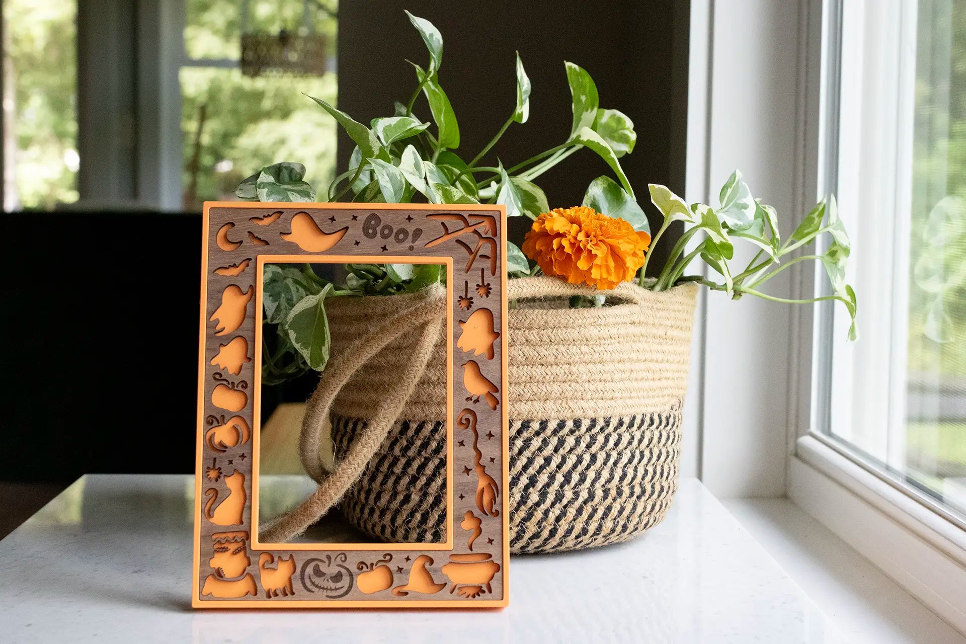 Cute Halloween keepsake frame for families and children to preserve Halloween memories year after year. Pictured is a lightweight, orange 3D printed picture frame with a laser cut walnut wooden inlay.