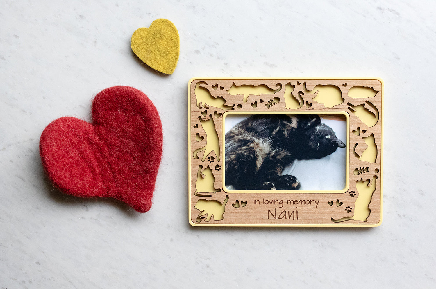 Yellow instax wide magnetic cat frame with laser cut cats doing cat things - sleeping, loafing, stretching, playing, chasing, and posing. The cherry wood inlay features cute cats, paw prints, and fish bones. There is an engraved personalized message that reads "in loving memory Nani".