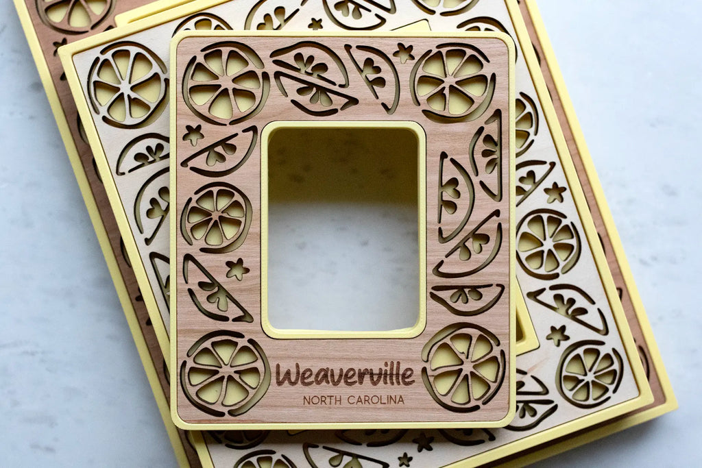 Laser lemon picture frames with magnets for refrigerator, lockers, and magnetic surfaces. These mini frames are yellow with cherry wood inlays and citrus decor.