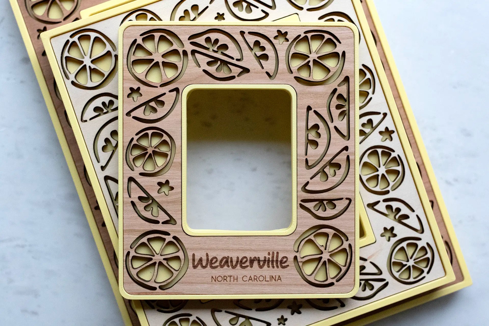 Laser lemon picture frames with magnets for refrigerator, lockers, and magnetic surfaces. These mini frames are yellow with cherry wood inlays and citrus decor.