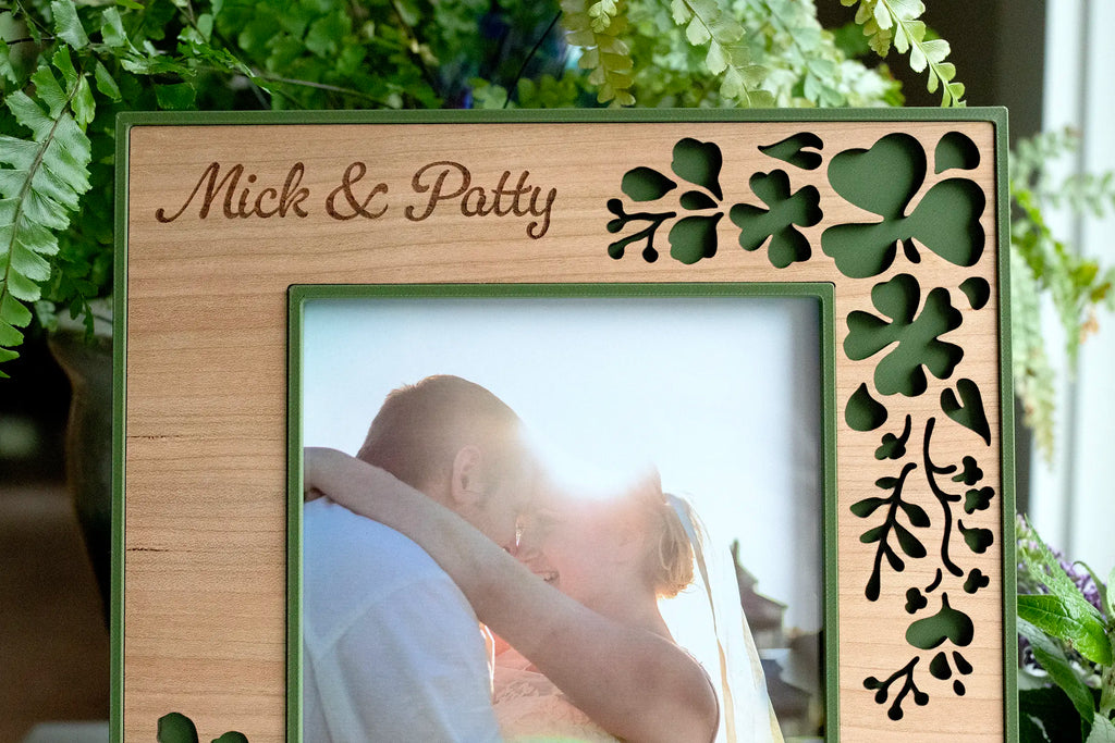 Personalized Irish wedding shamrock picture frame, laser-cut clover and engraved "Mick & Patty," holding a wedding photo. Available in 4x6, 5x7, and 6x8 sizes.