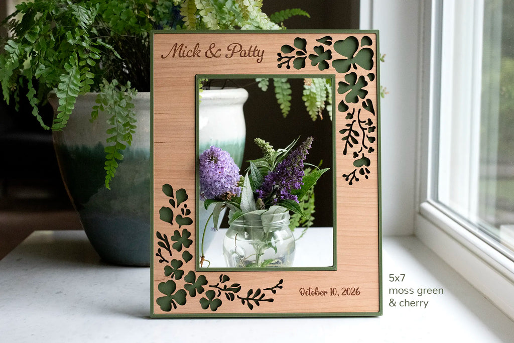 Personalized Irish wedding shamrock picture frame in cherry wood and moss green, engraved "Mick & Patty, Oct 10 2026".