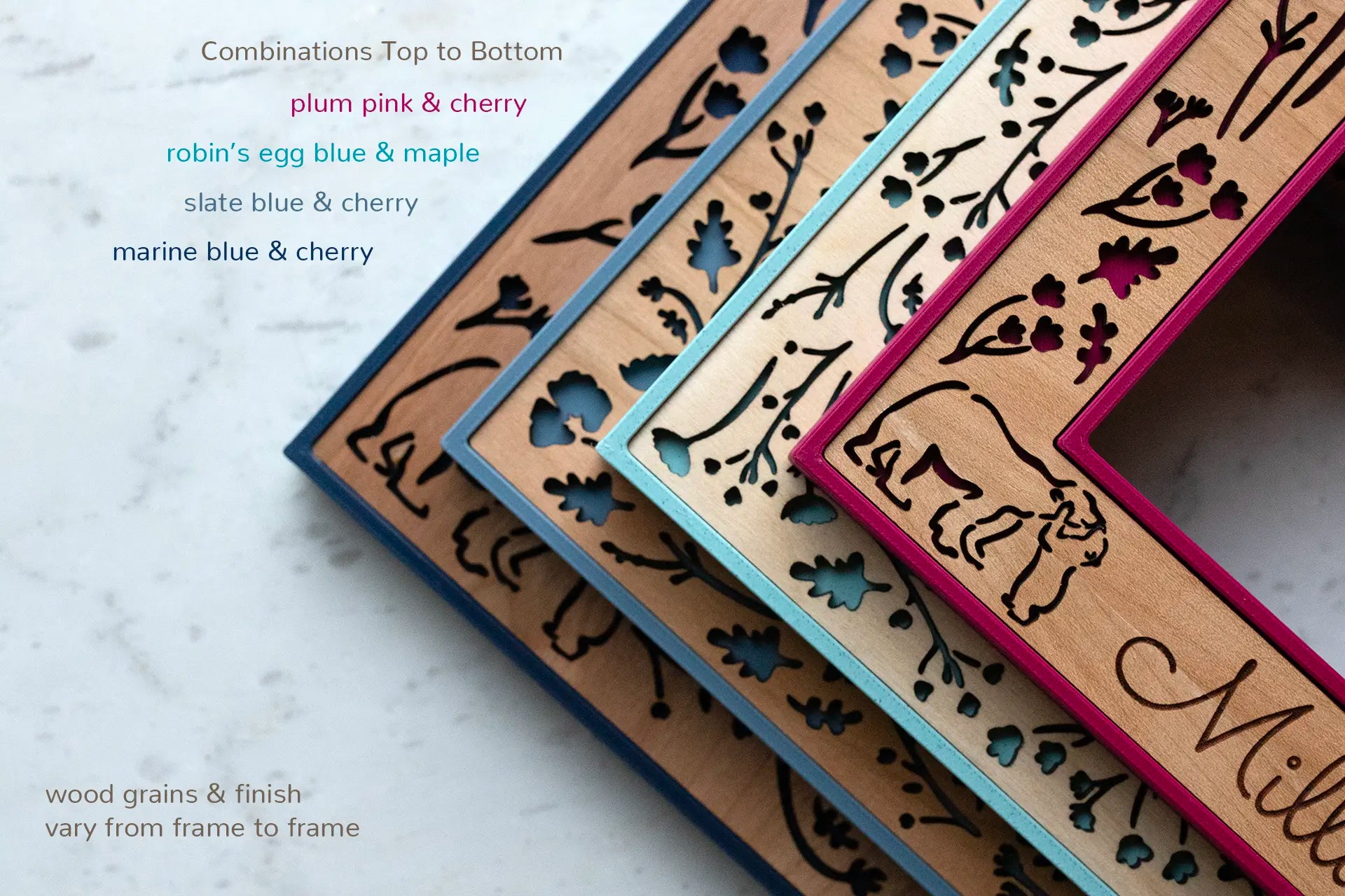 Four mama and baby bear woodlands frames stacked one on top of another. Colors include plum pink and cherry wood on top, followed by robin's egg blue and birch wood, slate blue and cherry, and marine blue and cherry. The frames are at an angle showing top view with laser cut details.