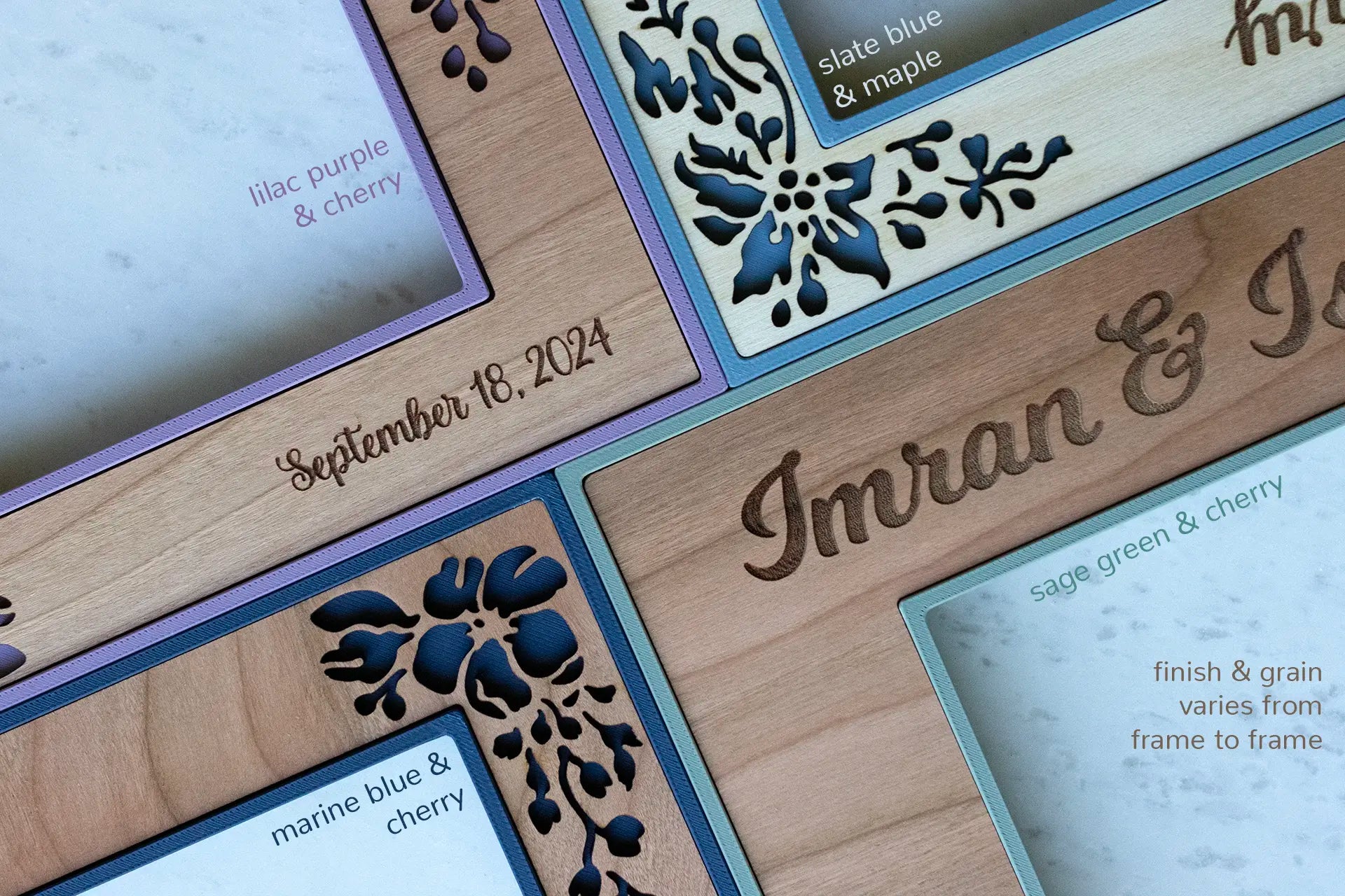A close-up detail view of various wood grains and personalized engravings on four wedding picture frames. The frames displayed have flowers cut out of the cherry and birch. The frame borders are colorful in sage green, lilac purple, and various shades of blue.