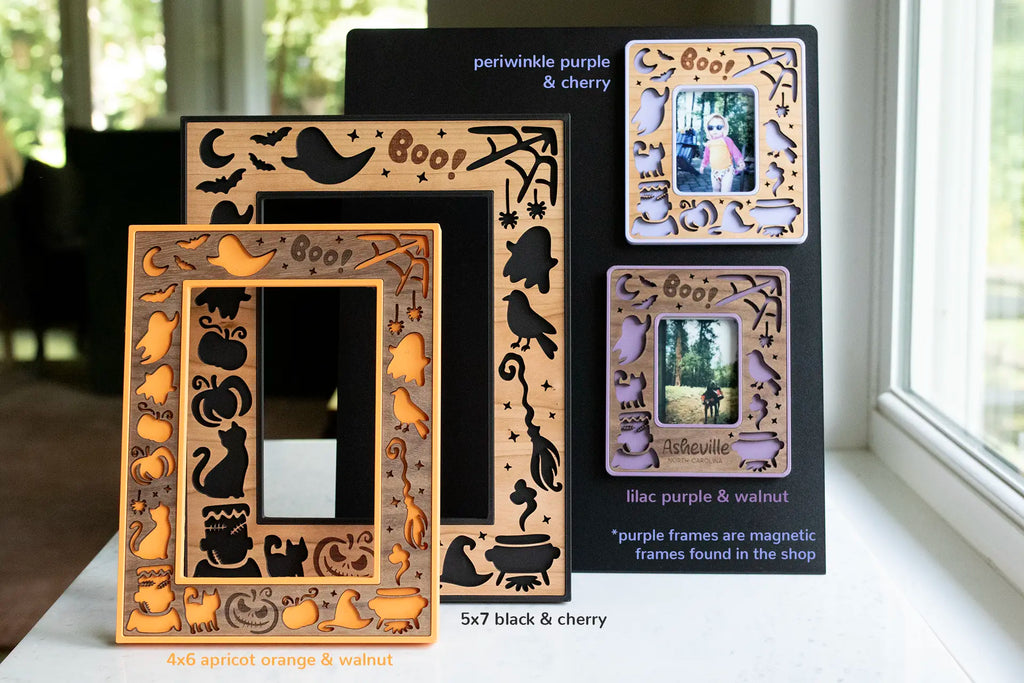 Handmade Halloween laser cut picture frames in black, orange, and purple. Frames feature pumpkins, ghosts, witch's hat and broom, bats, the moon and stars, and a cute "Boo!" engraved message. Personalize for a Halloween keepsake gift.