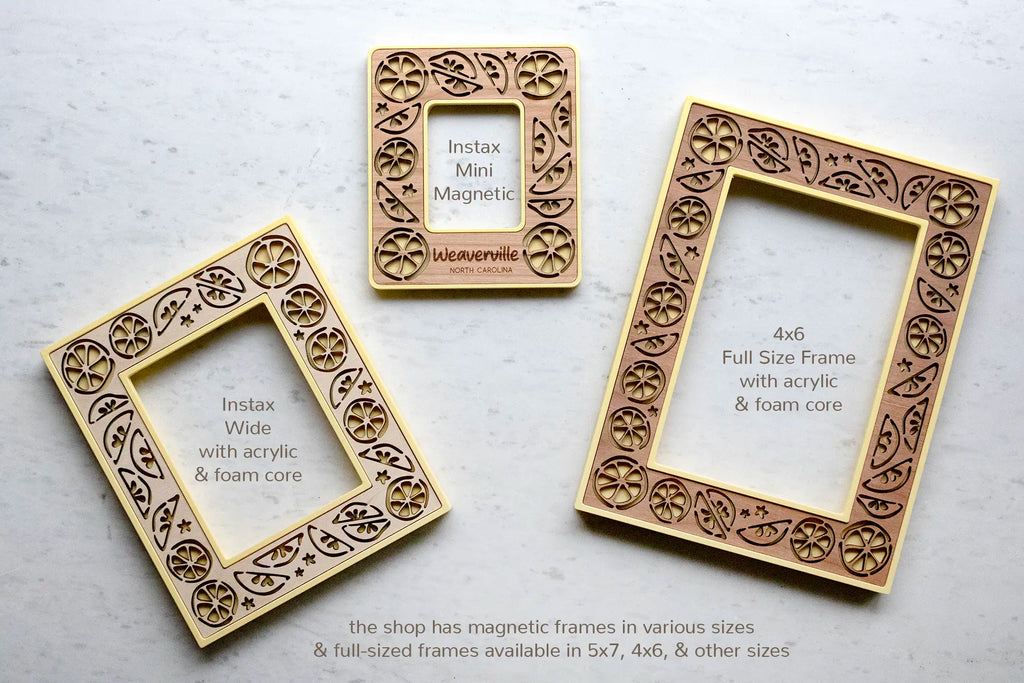 Yellow lemon picture frames with wooden inlays featuring whimsical, laser cut lemon designs. The frame on the right is a 4x6 picture frame. The frame on the left fits an Instax Wide photo. The magnetic frame in the middle fits an Instax Mini photo.