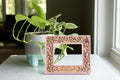 A personalized pink floral picture frame for a new mom keepsake gift. The frame holds a baby's sonogram photo. Picture frame can be personalized with a child's name and date of ultrasound photo or birth date. Frame features a custom laser cut floral design with personalized engraving details.