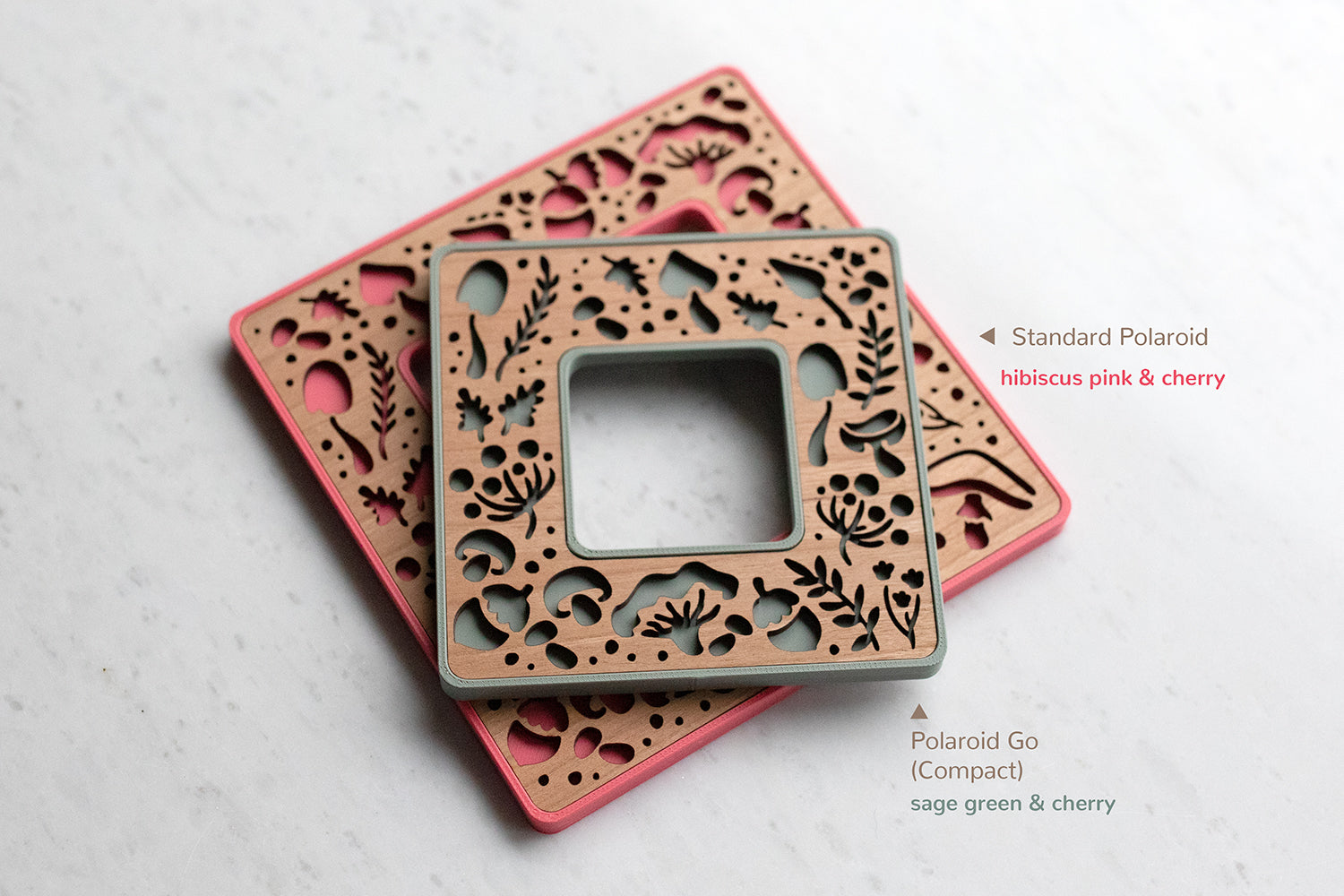Mini magetic polaroid frames with cute mushroom designs. The frames fit the two most common Polaroid photo sizes. The bottom frame is a bright pink color, and the top frame is a sage green color. These mini magnetic frames make great mushroom lover decor for your fridge.