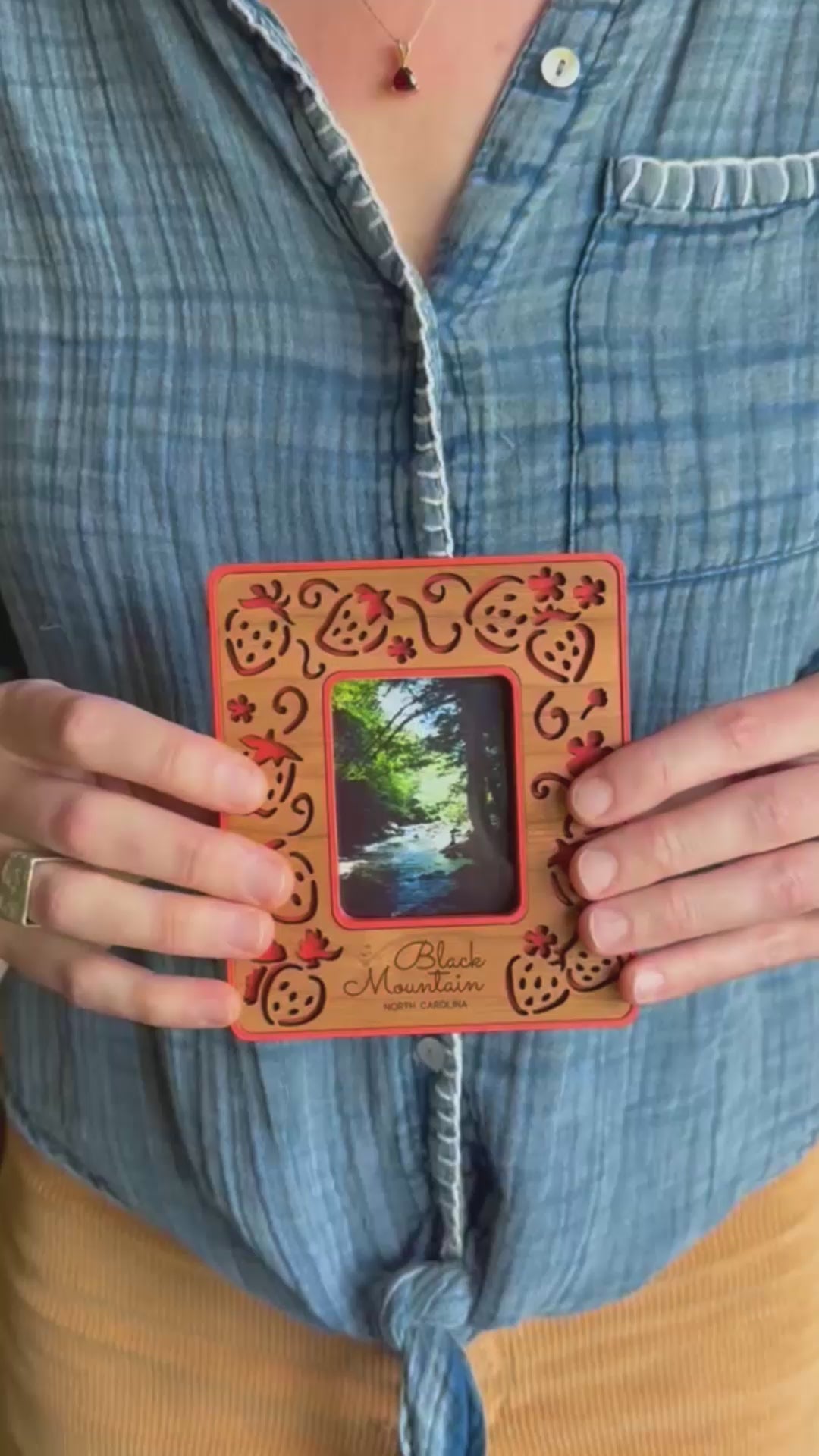 BellaForm Creative Instax mini photograph being inserted in magnetic frame with laser cut strawberry frame design.