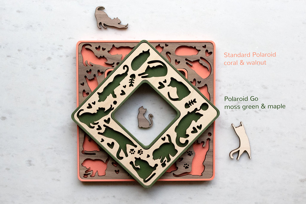 Magnetic polaroid frames for cat lovers in green and coral pink with walnut and maple wood inlays. The frames are custom laser cut and available in various colors, wood types, and made to order with or without personalization. These mini frames make great small gifts for cat owners.  The frames are surrounded by tiny laser cut wooden cats in cute cat positions.