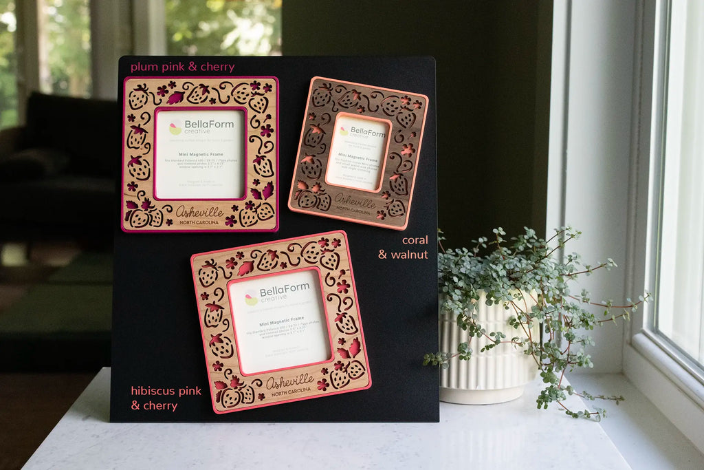 Laser-cut strawberry frames in various shades of pink with wooden inlays. Engrave any name, date, or message, or skip the text for an all-strawberry design. Frames are garden-inspired and handmade in Western North Carolina.