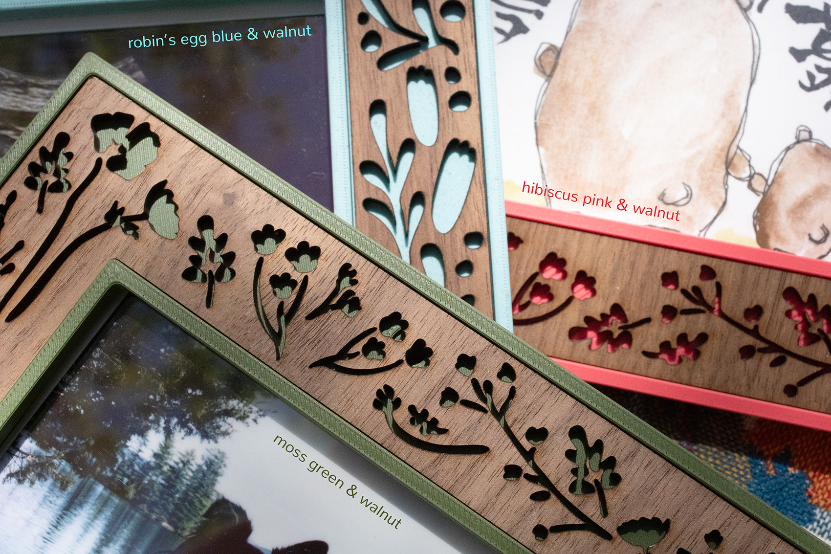 Mother's day mama and baby bear laser cut keepsake picture frames. Three colorful frames lying on a blanket, pictured in green, blue, and pink with walnut inlays.